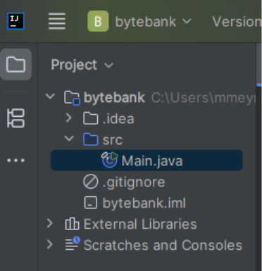 Zoom da visualização “Project” no IntelliJ IDEA, exibindo a estrutura do projeto “bytebank”. O diretório principal contém as pastas “.idea” e “src”. Dentro da pasta “src” está o arquivo “Main.java”, destacado em azul. Abaixo também aparecem os arquivos “.gitignore” e “bytebank.iml”. Na parte inferior da estrutura estão as seções “External Libraries” e “Scratches and Consoles”. 